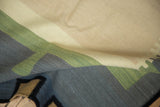 Folded detail of the contemporary kilim rug showing beige, sage, and charcoal flatweave.