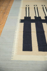 Detail of contemporary Kilim rug with dusty mallard green stepped border and black stripes.