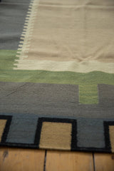 Intricate stepped geometric pattern in sage, charcoal, and sand on a contemporary Kilim rug.
