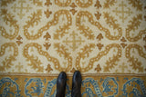 Vintage Spanish Alcaraz, full pile, ivory field with scrolling saffron tendrils and blue dragon border.