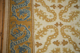 Vintage Alcaraz carpet's intact side cord selvage, full pile, and saffron-sky blue dragon border.
