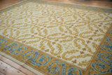 Alcaraz carpet's saffron scrolling tendrils on ivory, with denim blue dragon border.