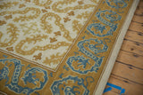 Denim blue dragon border, saffron tendrils, and side selvage of vintage Alcaraz carpet.