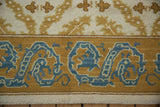 Vintage Alcaraz carpet's dragon border and scrolling floral tendrils in blue, gold, and ivory.