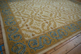 Vintage Spanish Alcaraz rug corner with blue dragon border and gold floral tendrils.