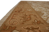 Meandering vine arabesque border of the Spanish Arts and Crafts rug in neutral tones.