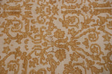 A close-up view of the carpet's full, even pile and dusty gold scrolling vinery.