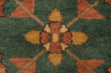 Hand-knotted Serapi design pile showing mallard green, terra cotta, and gold motif.