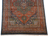 Vintage Indian Heriz rug corner featuring samovar turtle border, terra cotta, and deep blue.