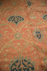 Detail of the hand woven Soumac rug's terra cotta, navy, and sage Arts and Crafts vinery.