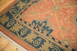 Vintage Indian Soumac rug corner, terra cotta field, dusty navy Arts and Crafts border.
