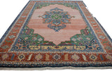 Geometric rust and blue border of a vintage Indian Serapi rug.