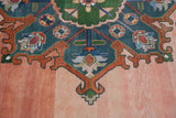Heavily abrashed dusty blush field meets bold geometric motif on this vintage Indian Serapi.