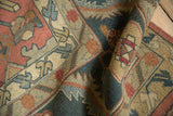 Woven texture and serrated vine floral border of vintage Indian Serapi Soumac rug.