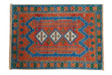 Hand-knotted vintage Indian Caucasian rug, vibrant sapphire, terra cotta, emerald geometric medallions.