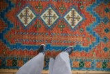 Vintage Indian Caucasian design rug with ivory diamond finned plant motif and geometric border.