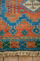 Vibrant geometric Indian Caucasian rug with sapphire blue, terra cotta pattern, emerald accents, fringe.