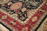 Soumac design carpet corner, wine red border, black floral field, and fringe.