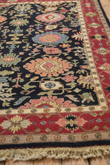 Vintage Serapi Soumac rug, black field with oversized floral palmettes, wine red border, fringe.