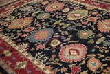 Vintage Indian Serapi Soumac carpet with wine red border and dark field floral palmettes.