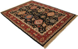 Traditional Indian Serapi Soumac rug with black field, oversized floral palmettes, wine red border.
