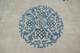 Intricate blue cloud-band and lattice roundel motif on a vintage Indian Peking rug.