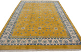 Art Deco rug corner showing saffron field, scattered blue floral motifs, and ivory heart border.