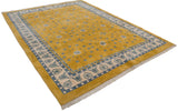 Corner of Art Deco Indian rug, saffron field, stylized blue floral border, and fringe.