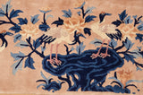 Vintage Peking rug showing two perched birds, blossomed lotus, and indigo blue foliage.