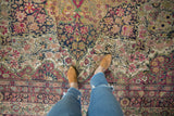 The low, even pile and detailed scrolled vinery of a late 19th-century Persian Kermanshah carpet.