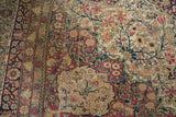 Hand-knotted detail of the sprawling vinery and floral blossoms on an antique Kermanshah rug.