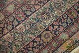 Detailed texture of a hand-knotted Persian Kermanshah carpet showing even wear to the knot heads.