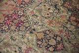 Hand-knotted pile of an antique Kermanshah carpet with even wear showing the foundation weave.