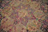 Detail of an antique Kermanshah carpet showing even wear to the knot heads and foundation.