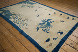 Detailed blue phoenix and butterflies on the antique Peking pictorial rug.