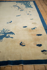 Pictorial antique Peking rug's ivory field, cobalt blue phoenix, and sky blue motifs.