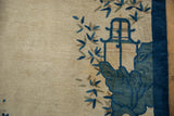 Antique Peking rug detail: pictorial blue house, rock bluffs, eucalyptus leaves, ivory field, cobalt border.