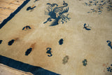Corner detail of antique Peking pictorial rug, showing intact dark blue selvage and rock bluffs.