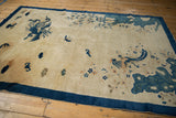 Cobalt blue border detail with pale blue rock bluff and delicate floral motifs.