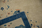 Antique Peking rug detail: cobalt blue side cord selvage, beige field, blue floral motifs.
