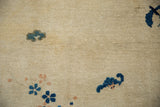 Textured pile of antique Peking rug, with delicate sky blue floral motifs on an antique ivory ground.