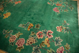 Emerald green field with blush, saffron, and wine red floral sprays of a Nichols Art Deco carpet.