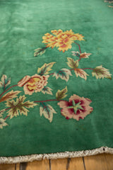 Emerald green field, expressive blush floral detail, ivory fringe, Nichols Art Deco rug.