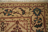 Ivory fringe, wine red border, and aqua, olive floral motifs of a Vintage Agra rug.