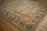 Vintage Indian Agra carpet with ivory paneled trellis design, colorful plants, and fringe.