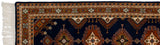 Ivory fringe and navy blue selvage of an Indian Turkmen runner's rust geometric border.