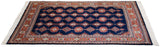 Vintage Indian Turkmen carpet with staggered geometric plant motifs and rust-toned borders.