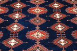 Vintage Indian Turkmen carpet pile featuring navy blue, rust geometric plant motifs.