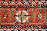 Vintage Indian Turkmen carpet: rust geometric plant motif, navy and ivory hook patterns.
