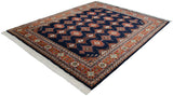 Navy blue Indian Turkmen rug with geometric plant and hook motifs, rust border.